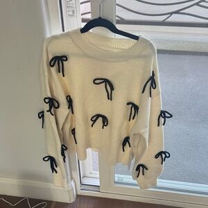 Elegant Cream Sweater with Black Bow Details